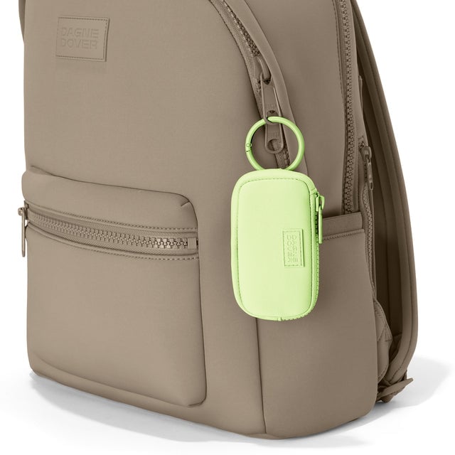 Dagne Dover Mara Keychain in a vibrant, creamy green clipped onto a backpack. hover