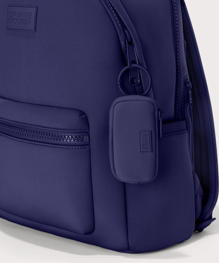 Mara Keychain in a jewel-toned, deep blue with strong purple undertones. front angle showing keychain on a dakota backpack. 