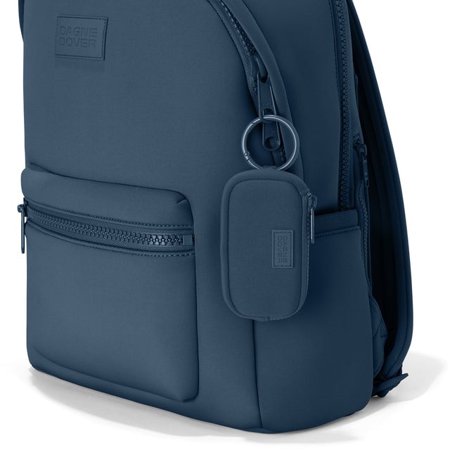 Dagne Dover Mara Keychain in a medium grey-blue with a touch of turquoise clipped onto a backpack. hover
