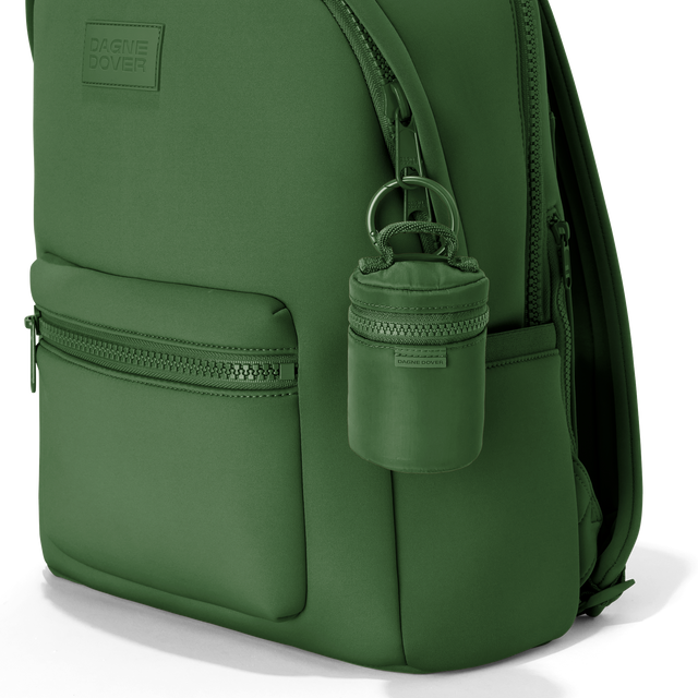 Dagne Dover Mila Keychain in a rich, classic forest green clipped onto a backpack. hover
