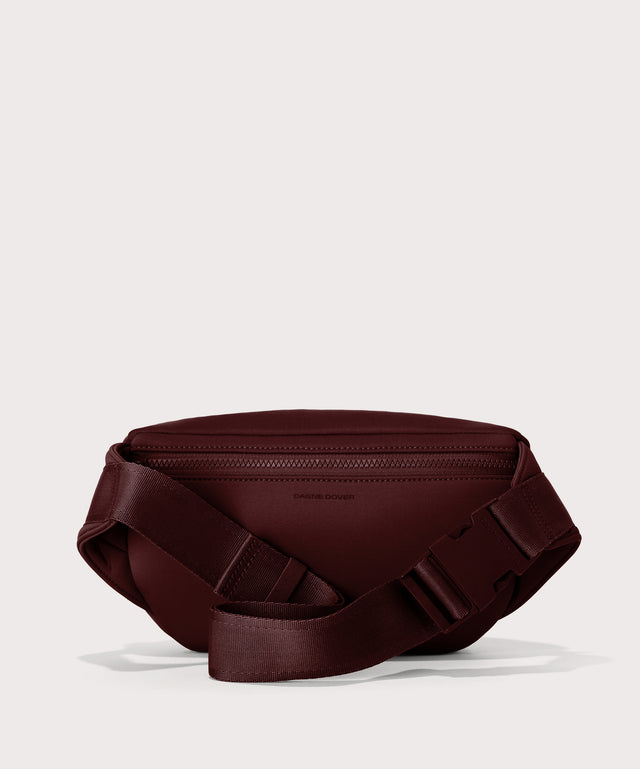 Dagne Dover Jax Large Fanny Pack in a deep brown with purple undertones seen from the back.