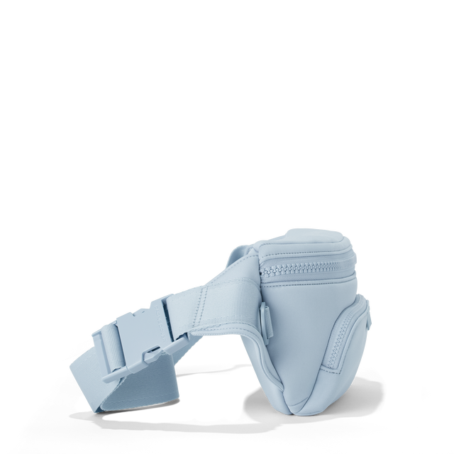 Dagne Dover jax large fanny pack in an airy, lighter sky blue seen from an angle.
