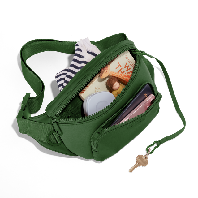 Dagne Dover jax large Fanny Pack in a rich, classic forest green unzipped, exposing the interior pockets. hover
