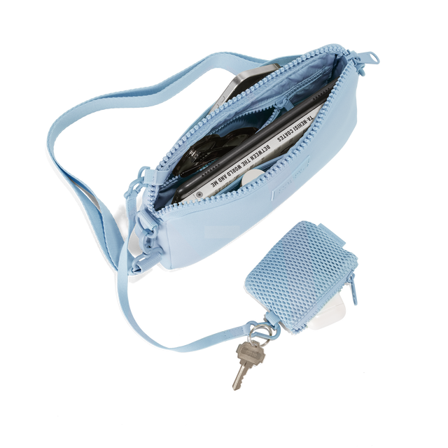 Dagne Dover Nora Shoulder Bag in an airy, lighter sky blue, unzipped topdown. hover
