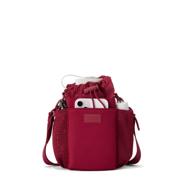 Dagne Dover Sloan Water Bottle Sling in a punchy, saturated deep red containing a water bottle and accessories.