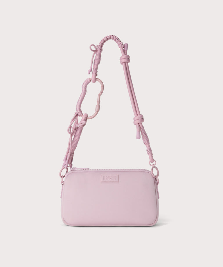 corded strap on a nora shoulder bag in a  cool, powdery pink with soft grey undertones.