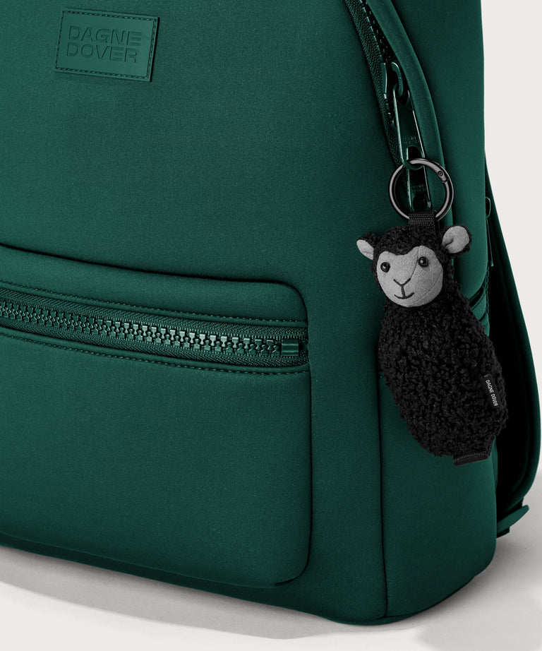Black sheep keychain in a black In a  Faux Shearling  a soft, wool-like plush made with recycled materials
front view on a dakota backpack