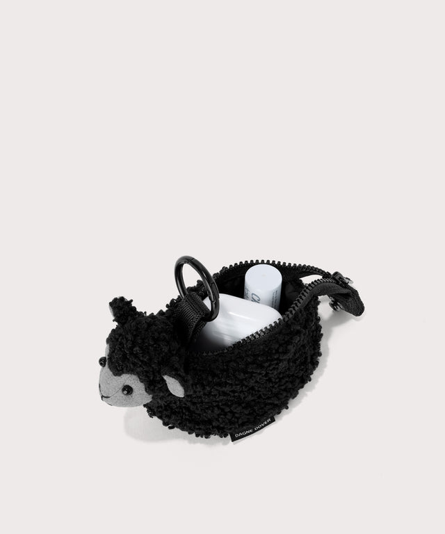 Black sheep keychain in a saturated, jewel-toned deep green with bold blue undertones . unzipped, top down view.  In a  Faux Shearling  a soft, wool-like plush made with recycled materials
