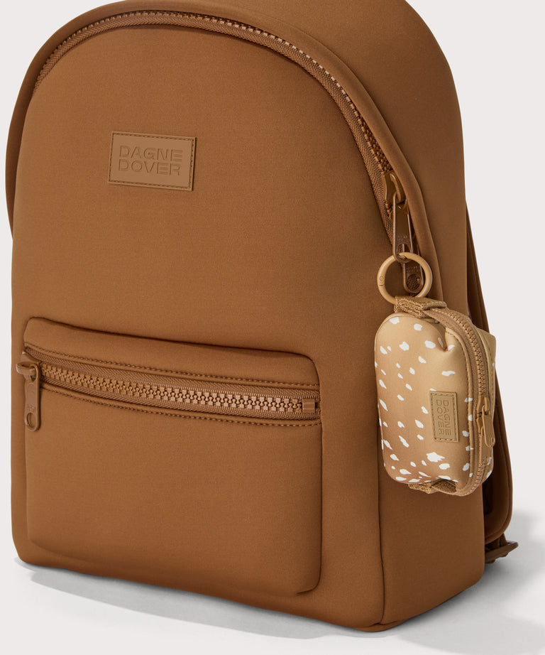 Hunter keychain in an understated, neutral fawn print with a range of rich browns.  front angle view showing the keychain on a dakota backpack. 
