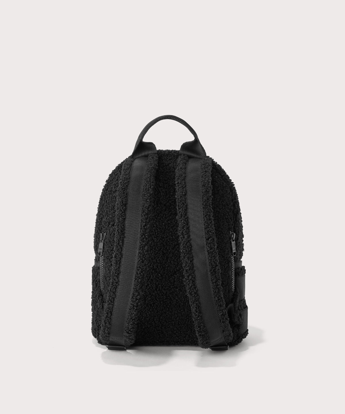 Dakota Small backpack pack in a black  Back view.  In a  Faux Shearling  a soft, wool-like plush made with recycled materials
