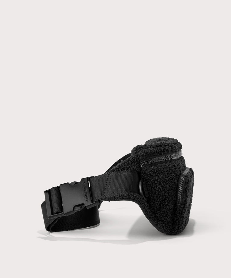 Jax fanny pack in a black..  side angle view  In a  Faux Shearling  a soft, wool-like plush made with recycled materials
