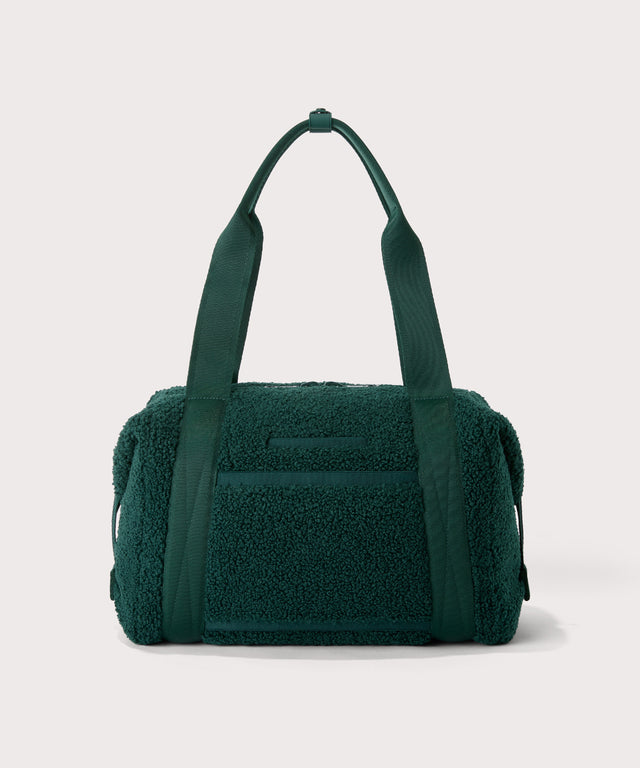 Medium landon carryall in a saturated, jewel-toned deep green with bold blue undertones.  Back view.  In a  Faux Shearling  a soft, wool-like plush made with recycled materials
