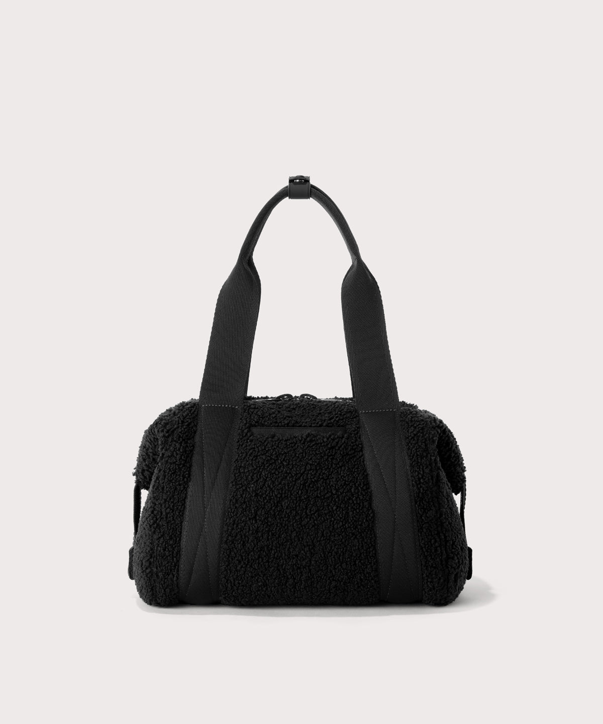 small landon carryall in a black.  Back view.  In a  Faux Shearling  a soft, wool-like plush made with recycled materials
