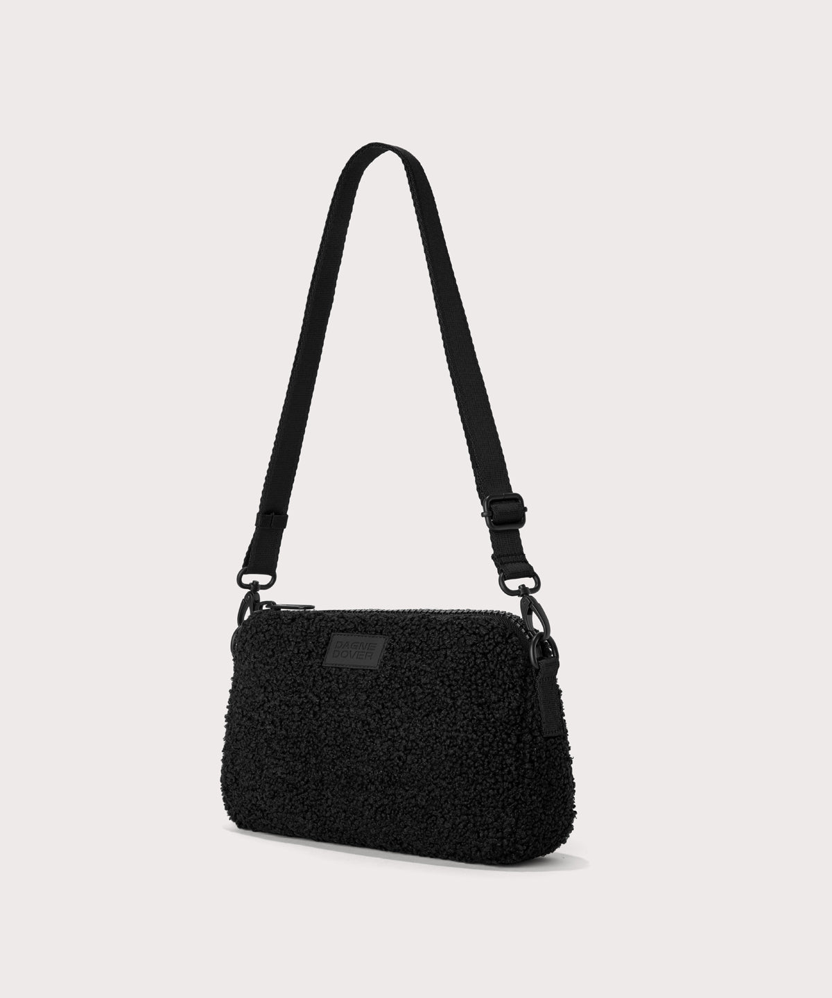 nora shoulder bag in a black..  side angle view  In a  Faux Shearling  a soft, wool-like plush made with recycled materials
