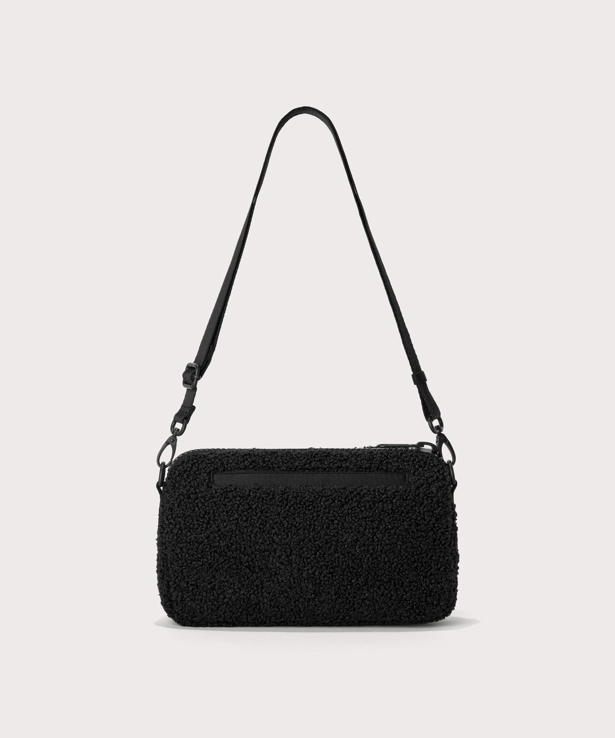 nora shoulder bag in a black.  Back view.  In a  Faux Shearling  a soft, wool-like plush made with recycled materials
