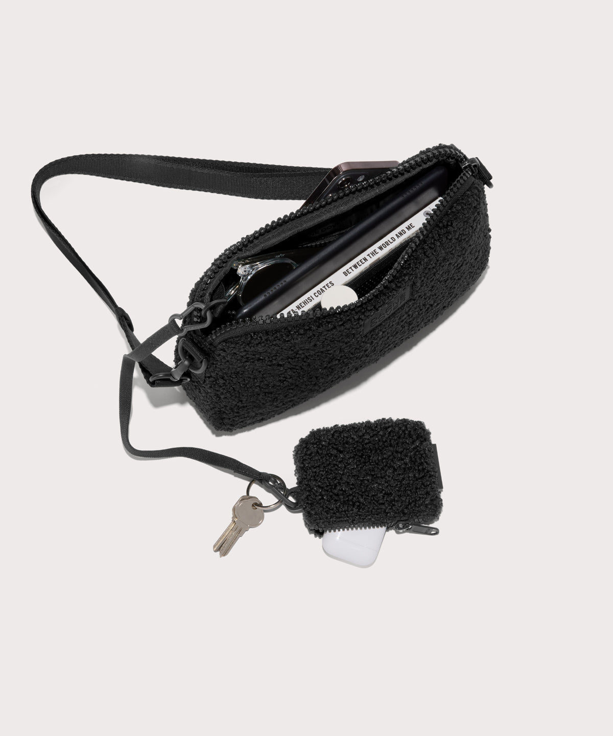nora shoulder bag in a black . unzipped, top down view.  In a  Faux Shearling  a soft, wool-like plush made with recycled materials
