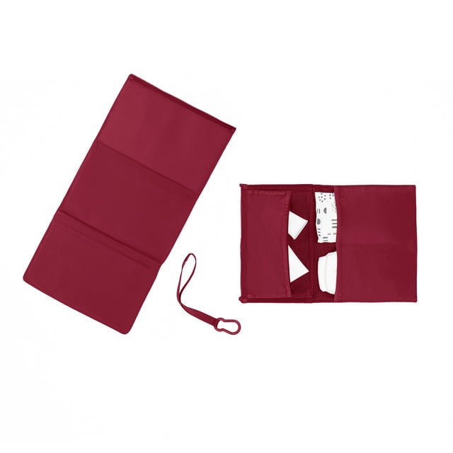 hover - Dagne Dover Joey Changing Kit in spice red unfolded, revealing the interior zipper pocket and interior slip pockets.