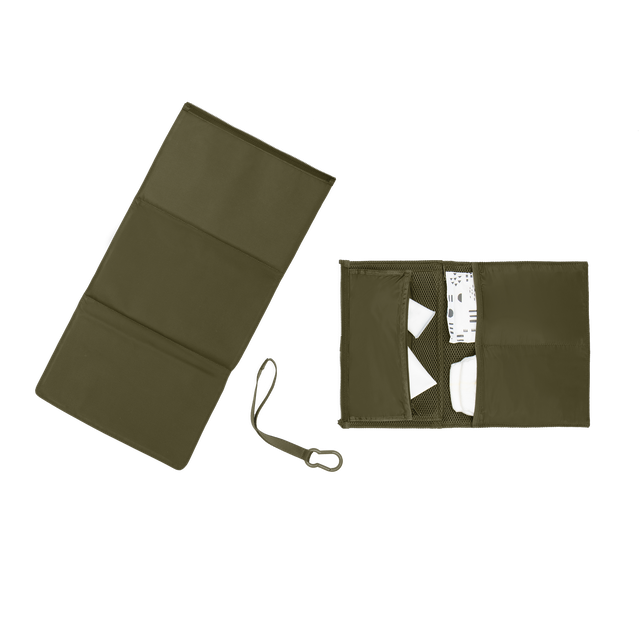 hover - Dagne Dover Joey Changing Kit in dark green unfolded, revealing the interior zipper pocket and interior slip pockets.