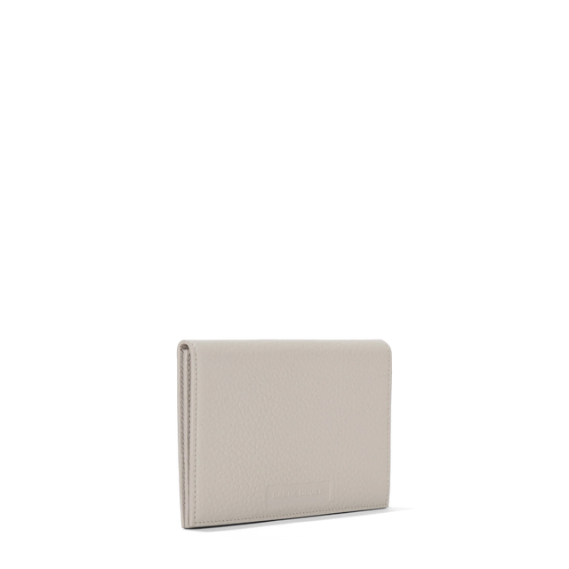 Dagne Dover Accordion Travel Wallet in white seen from an angle.