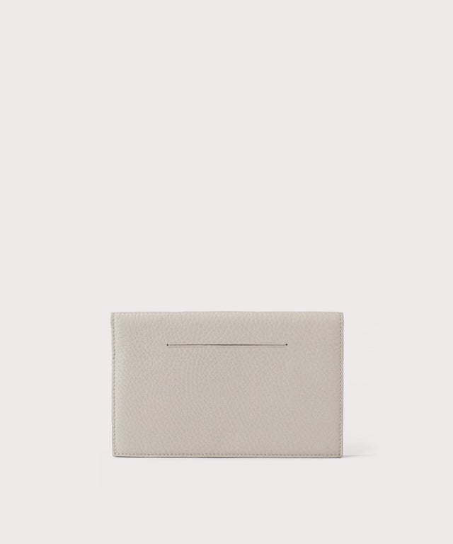 Dagne Dover Accordion Travel Wallet in light grey, revealing the external card slot.
