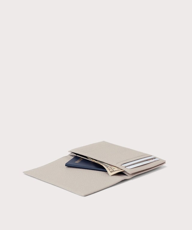 Dagne Dover Accordion Travel Wallet in light grey opened, revealing the internal card slots and internal gusseted card and passport slots.