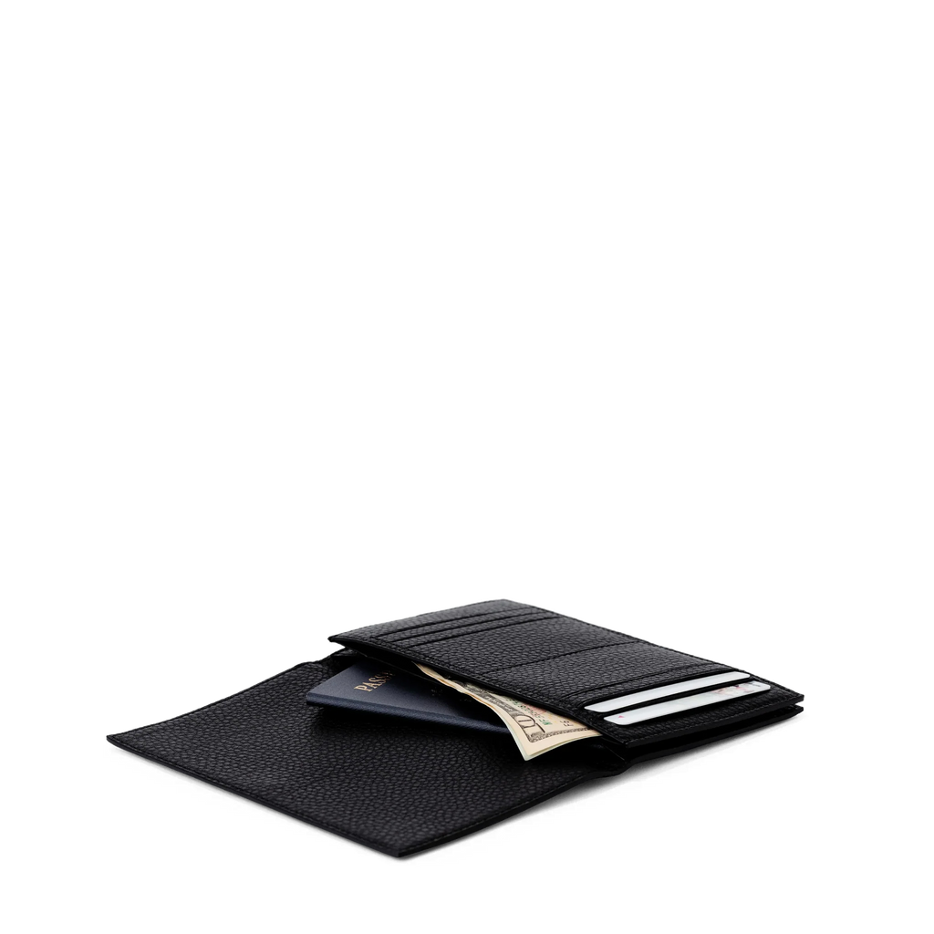  - Dagne Dover Accordion Travel Wallet in black opened, revealing the internal card slots and internal gusseted card and passport slots.