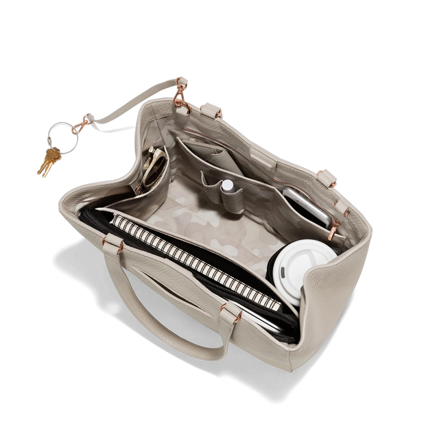 hover - Dagne Dover medium Allyn Tote in grey with objects inside the interior pockets.