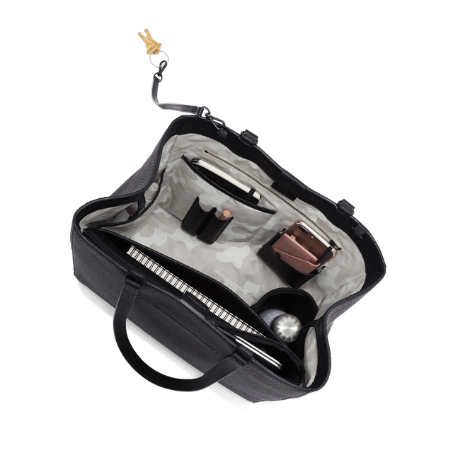 hover - Dagne Dover large Allyn Tote in black with objects inside the interior pockets.