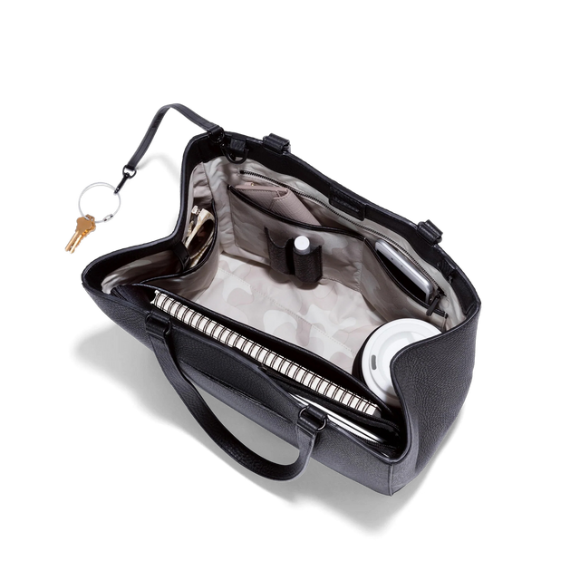 hover - Dagne Dover medium Allyn Tote in black with objects inside the interior pockets.
