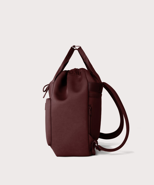 Rhys Backpack in a deep brown with purple undertones seen from the side.