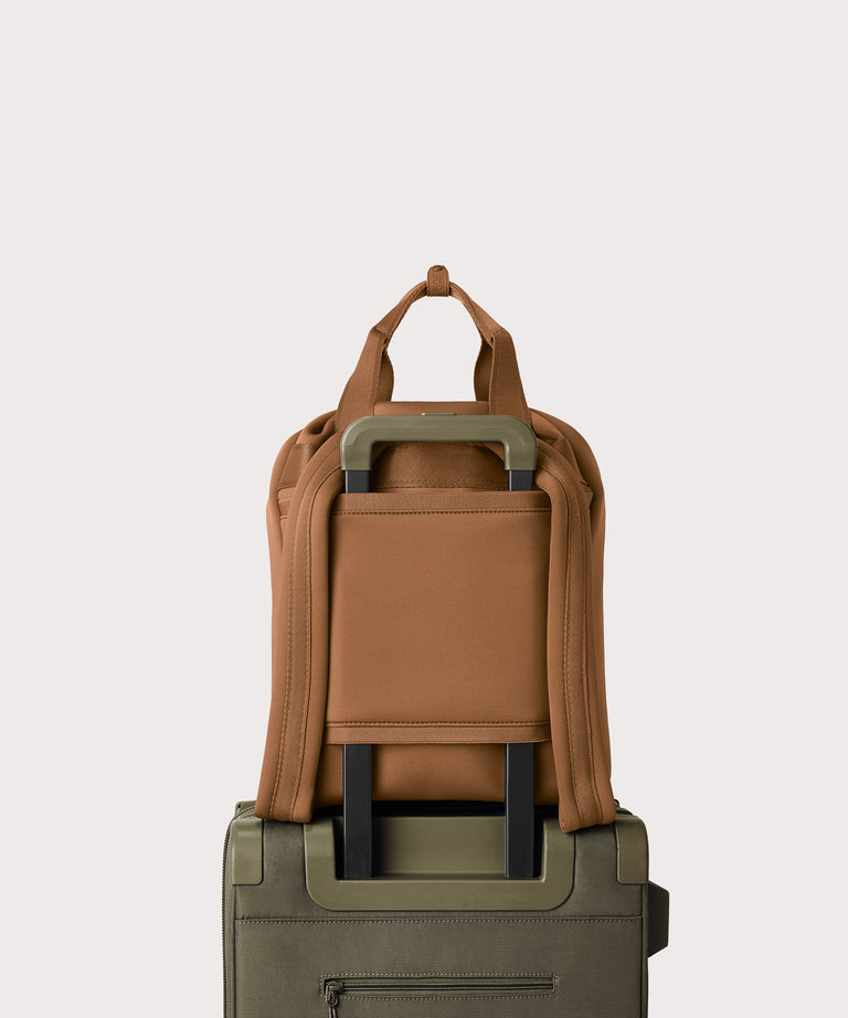 Rhys in a saturated, warm medium-brown with burnt orange undertones displaying luggage sleeve
