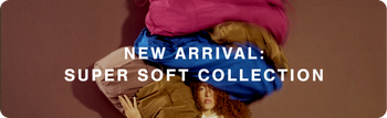 A promotional banner with the text 'NEW ARRIVAL: SUPER SOFT COLLECTION' over a pile of soft, plush bags in bright pink, blue, and tan, set against a solid mauve background.