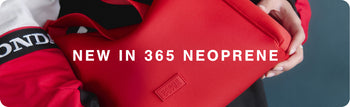 Red neoprene jacket held by a person with '365 Neoprene' branding.