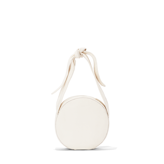 Dagne Dover Luna Shoulder Bag in white with the adjustable shoulder handle shortened.