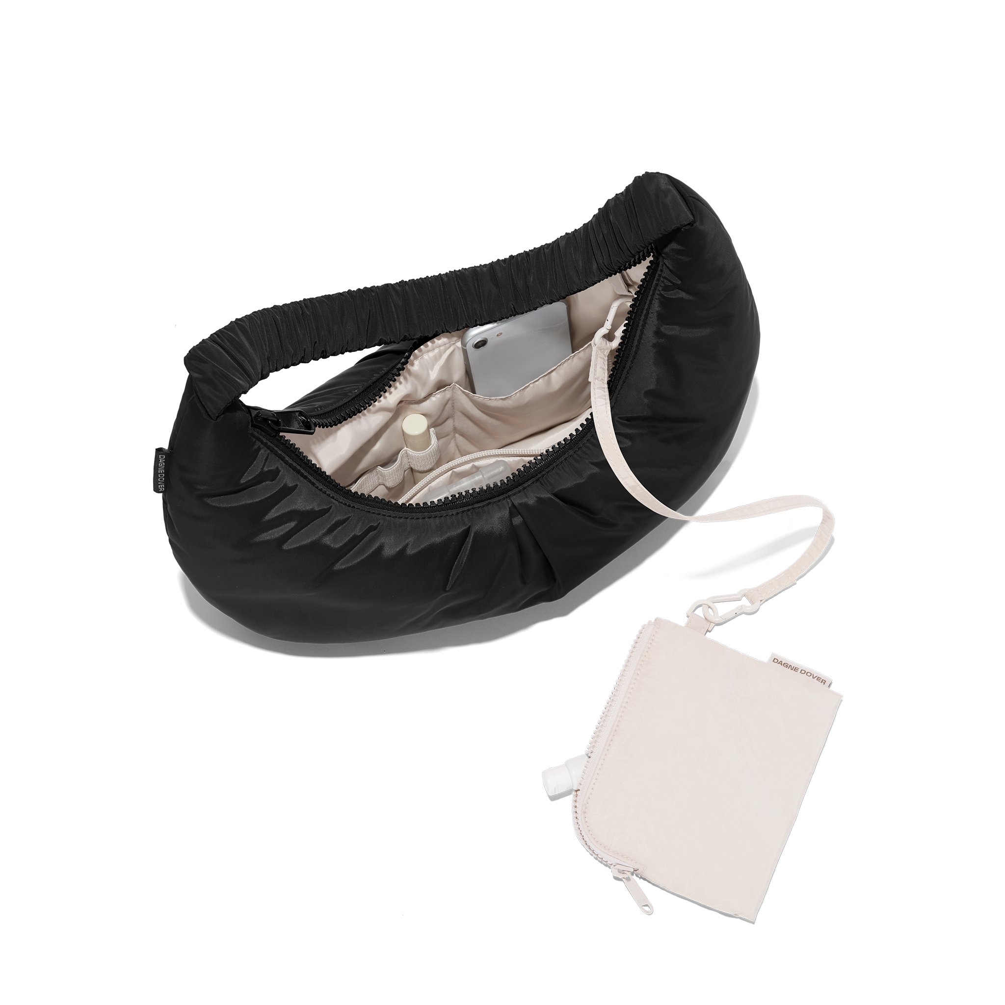 hover - Dagne Dover Rider Shoulder Bag in black unzipped, revealing the interior elastic loops, interior zip pocket, and removable zippered pouch.