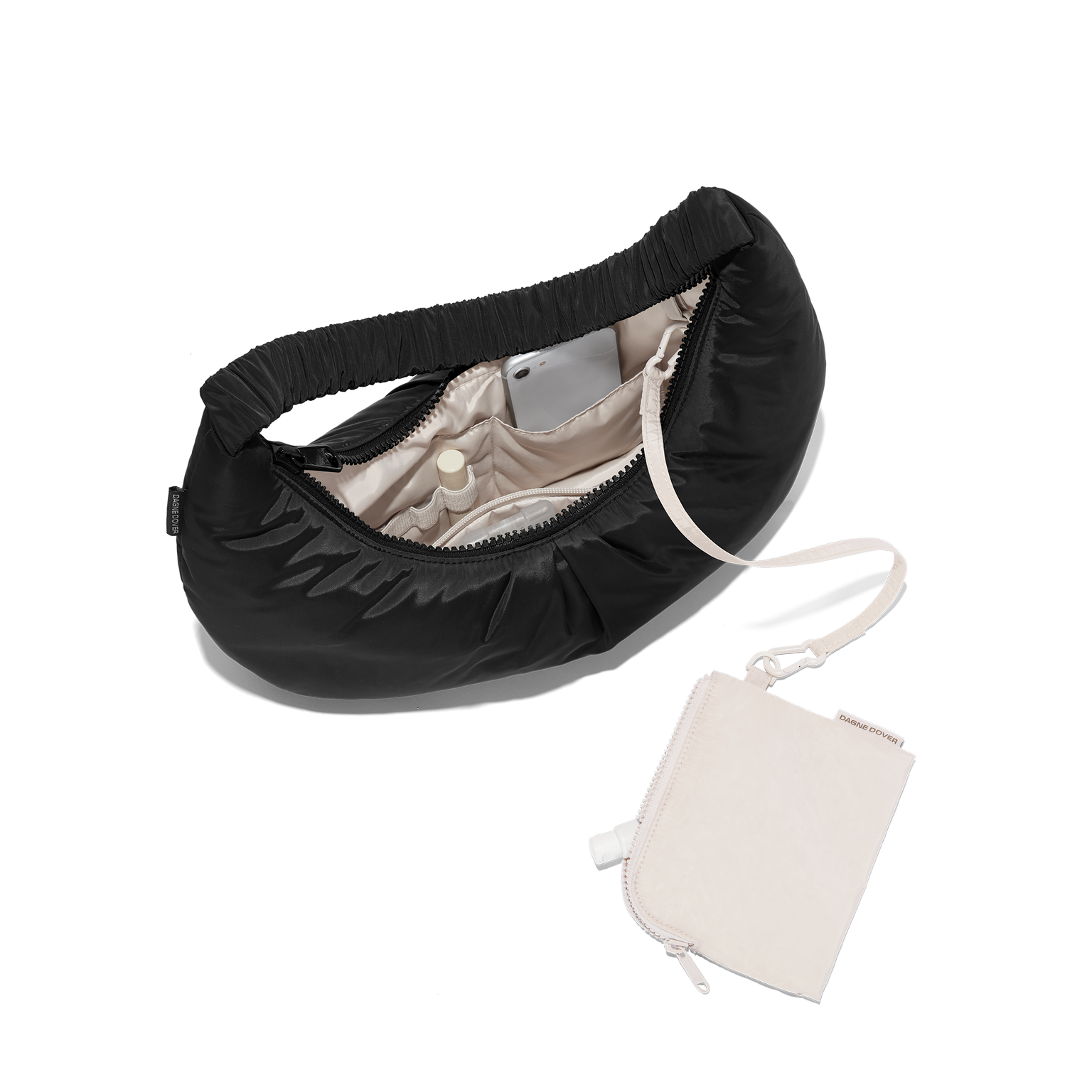 hover - Dagne Dover Rider Shoulder Bag in black unzipped, revealing the interior elastic loops, interior zip pocket, and removable zippered pouch.
