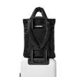 Dagne Dover Jemi Puff Tote in black strapped to luggage with the luggage-handle sleeve.