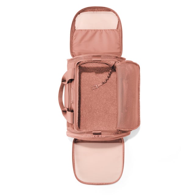 Dagne Dover Large Kyoto Pet Carrier in a warm dust pink seen unzipped, top down view.