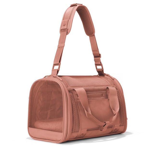 Dagne Dover Small Kyoto Pet Carrier in a warm dust pink seen from a back angle with crossbody strap.
