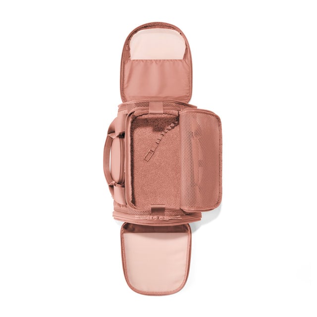 Dagne Dover Small Kyoto Pet Carrier in a warm dust pink seen unzipped, top down view. 