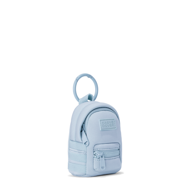 Dagne Dover Dakota Keychain in an airy, lighter sky blue seen from an angle.
