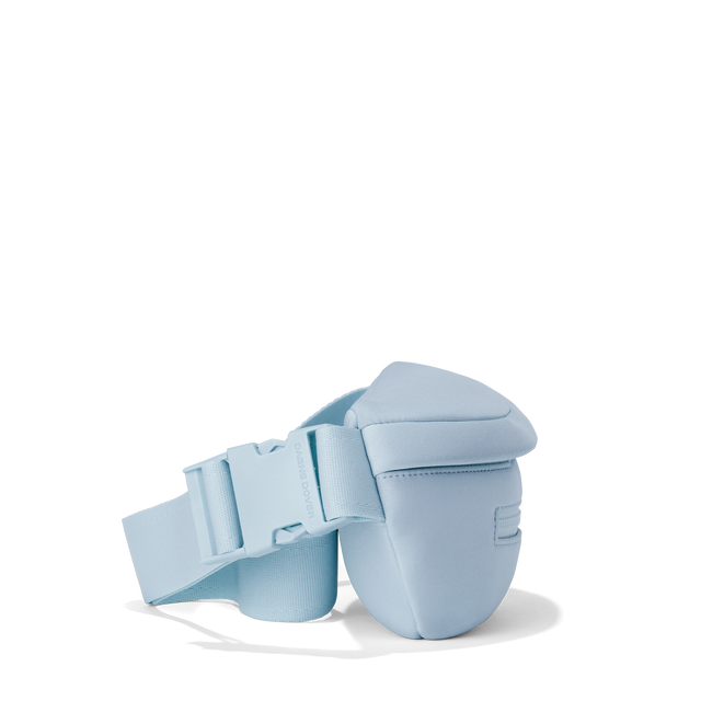 Dagne Dover ace fanny pack in an airy, lighter sky blue seen from an angle.
