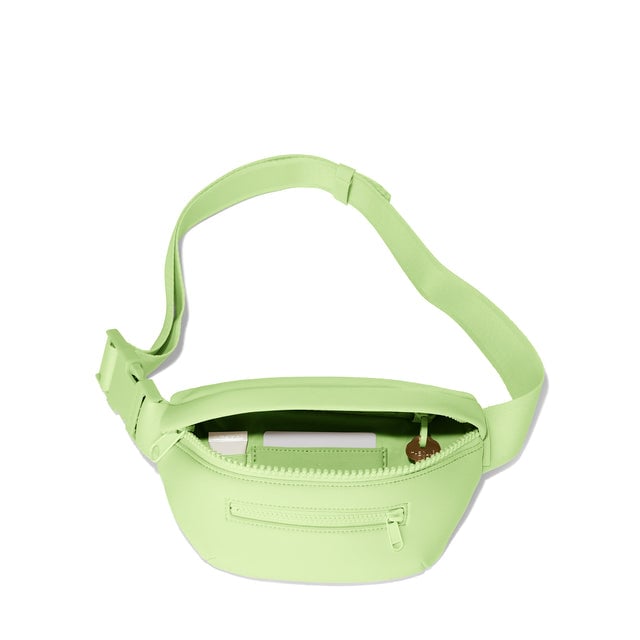 Dagne Dover Ace Fanny Pack in matcha green unzipped, exposing the interior pockets. hover