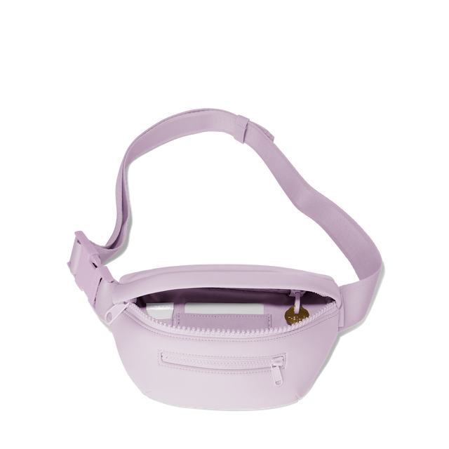 Dagne Dover Ace Fanny Pack in a soft purple with grey undertones unzipped, exposing the interior pockets. hover
