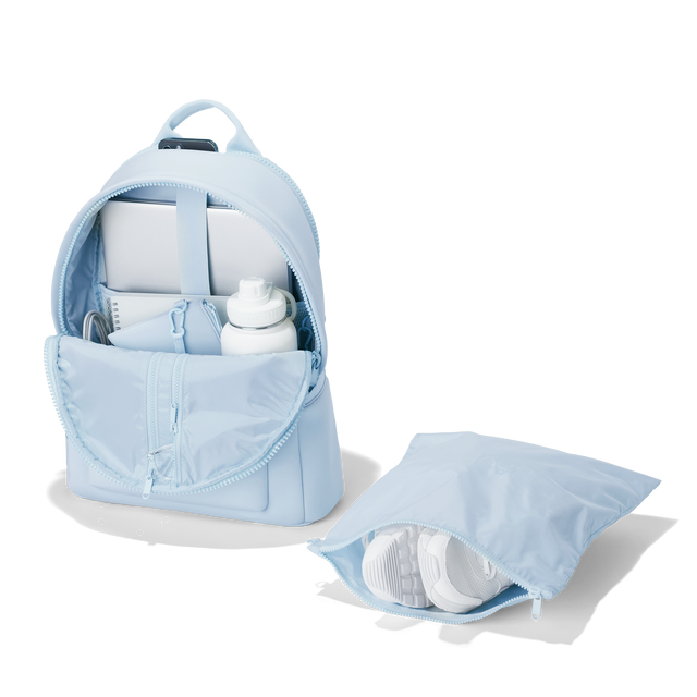 Dagne Dover large Dakota Neoprene Backpack in An airy, lighter sky blue unzipped, showing the interior pockets and shoe bag. hover