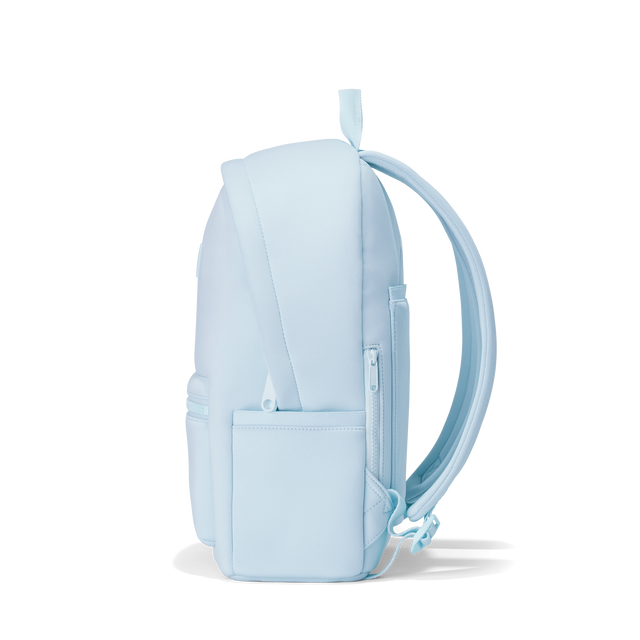 Dagne Dover medium Dakota Neoprene Backpack in an airy, lighter sky blue seen from the side.
