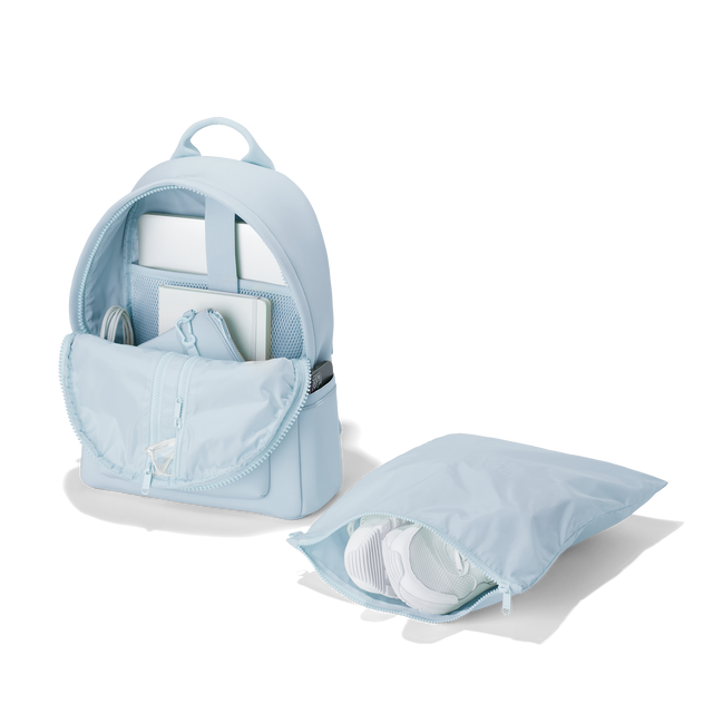 Dagne Dover medium Dakota Neoprene Backpack in an airy, lighter sky blue unzipped, showing the interior pockets and shoe bag. hover

