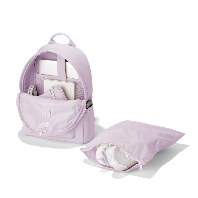 Dagne Dover medium Dakota Neoprene Backpack in a soft purple with grey undertones unzipped, showing the interior pockets and shoe bag. hover
