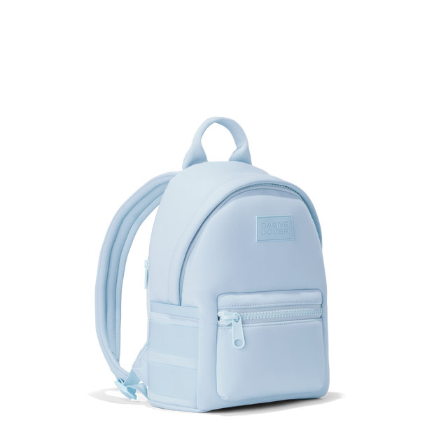 Dagne Dover small Dakota Neoprene Backpack in an airy, lighter sky blue seen from an angle.
