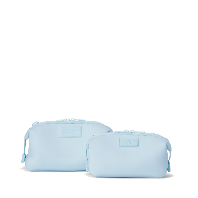 Dagne Dover Small and Large Hunter Toiletry Bags in an airy, lighter sky blue.
